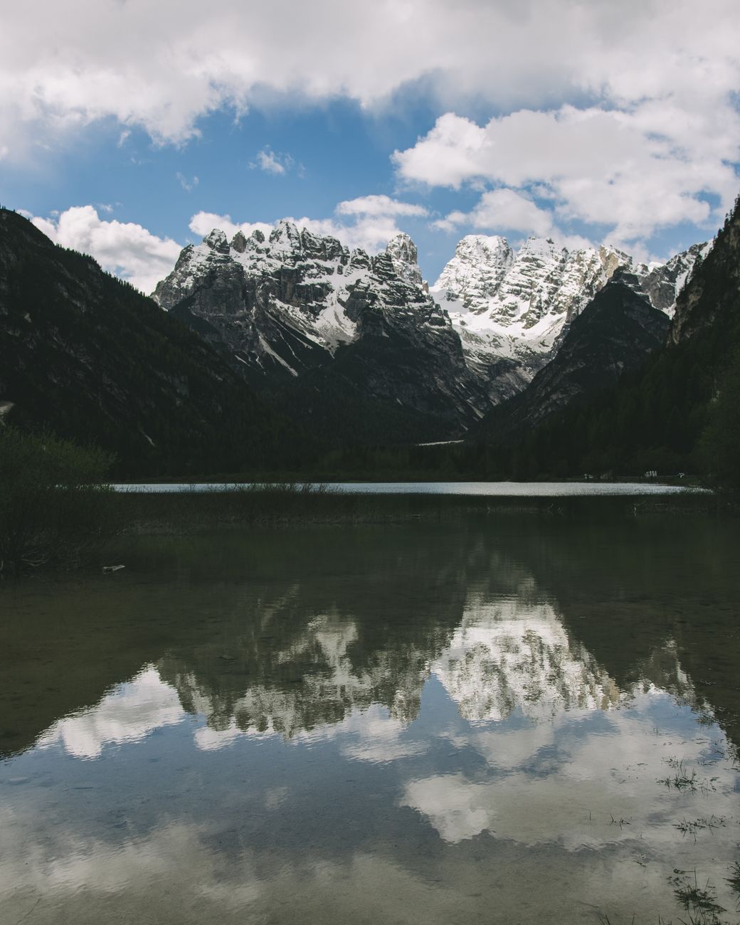 Dolomites limestone peaks reflected in alpine lake